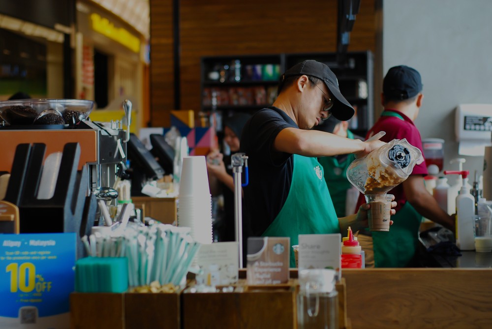 Image of a Starbucks barista making a drink