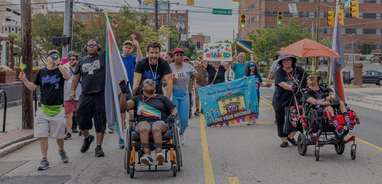 An image of disabled folks and allies in a recent protest against Medicaid cuts that will harm disabled folks and their communities.