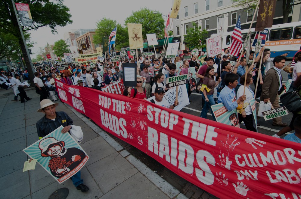 Demonstrators in Washington, DC protest against workplace immigration raids.